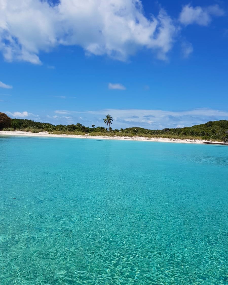 Boat anchored near a shallow reef and sandbar